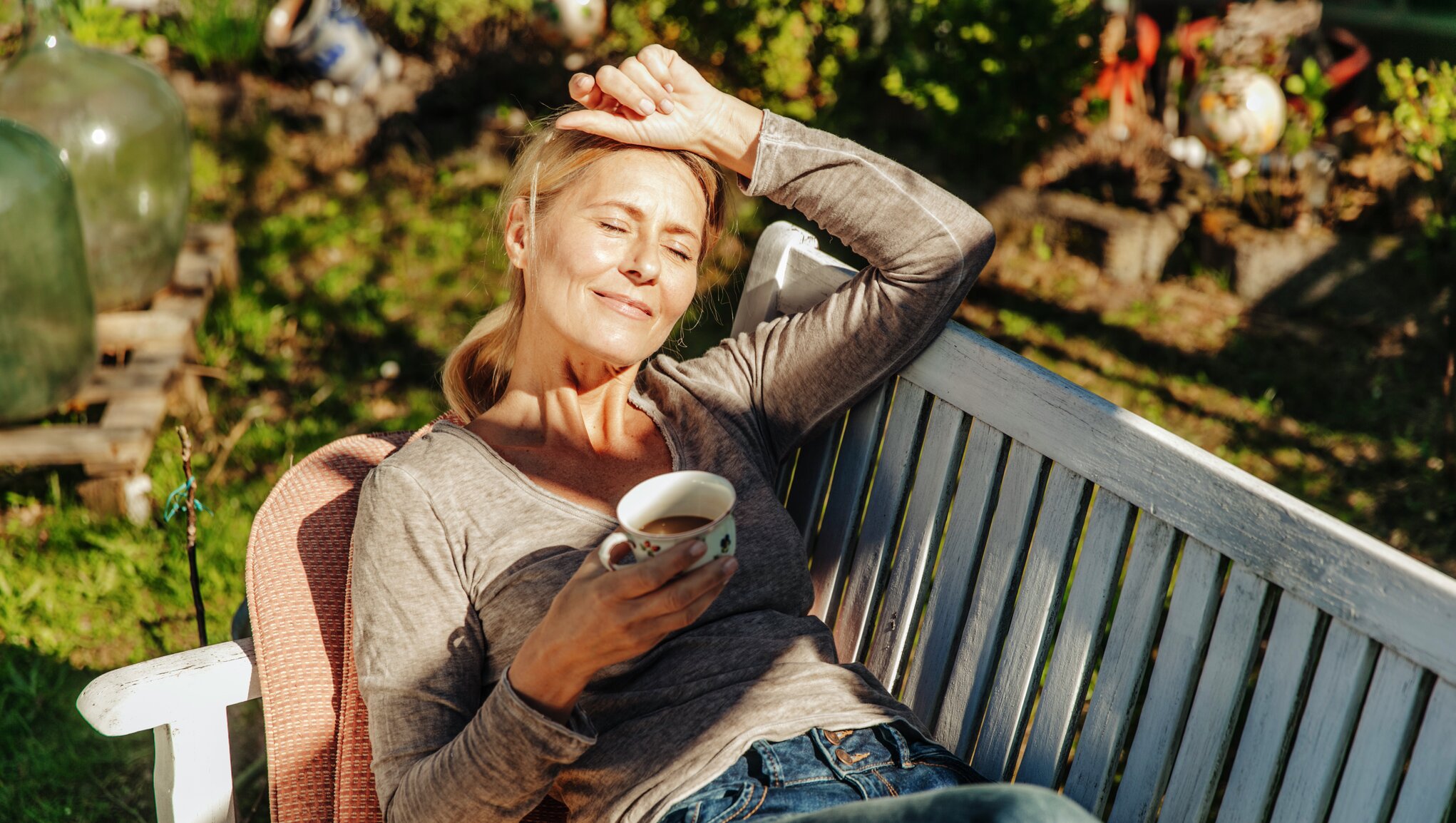 person enjoying a cup of coffee in the sun.