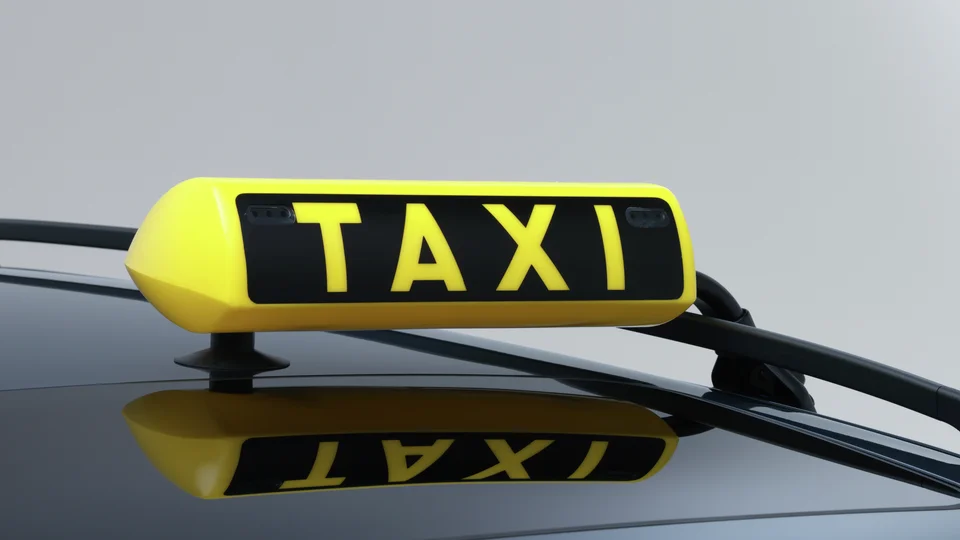 Taxiskylt monterad på biltak.