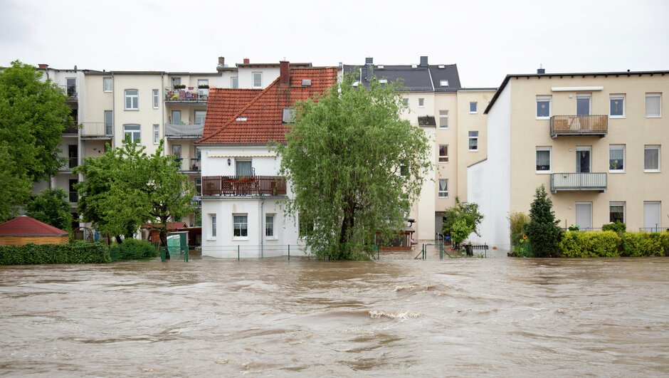 river flooding between houses
