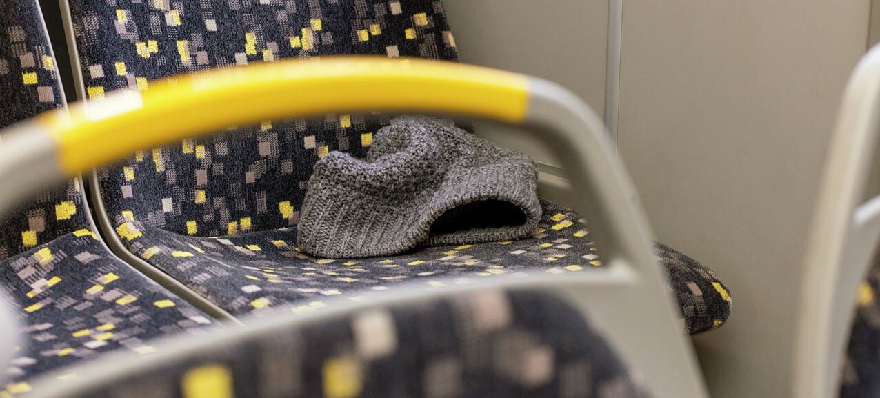 Picture of a hat left behind on a bus seat.