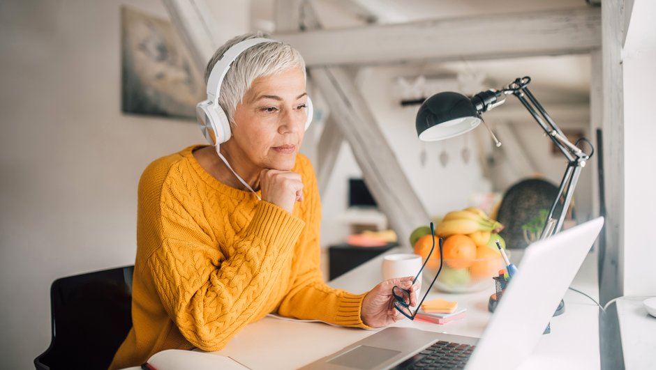 woman working with computer and wearing a headset.