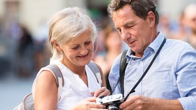 Mies ja nainen katsovat valokuvia kamerastaan